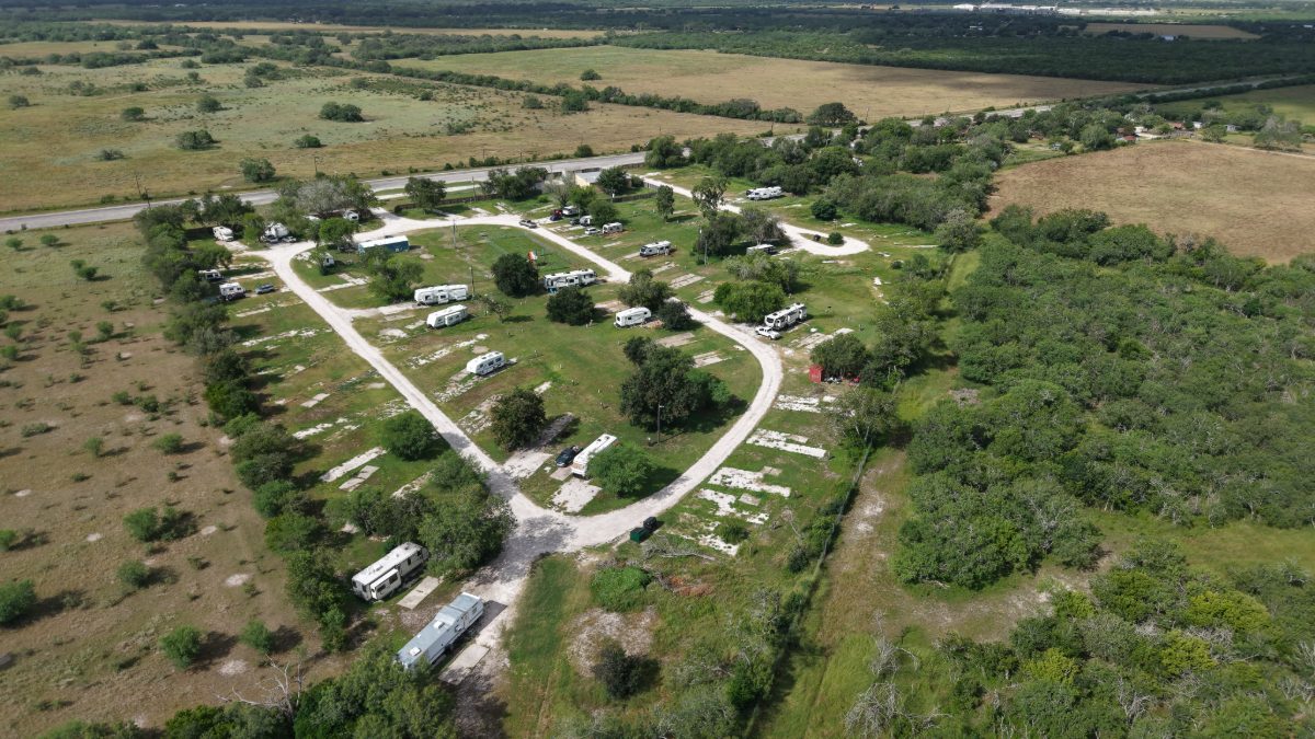 Aerial drone view of the whole Texas Rose RV Park property and the surrounding Bee County pasture, Highway 202 running past the top of the frame
