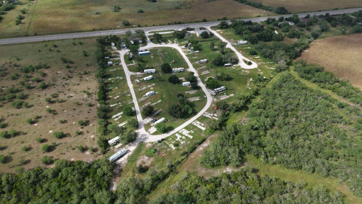 Aerial view of RV sites and open concrete pads at The Texas Rose RV Park, looking north toward Highway 202