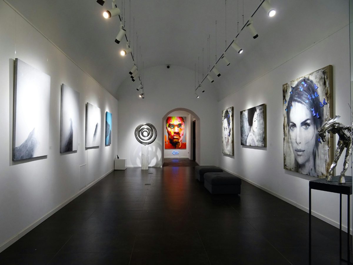 A brightly lit gallery hung with contemporary paintings and sculpture