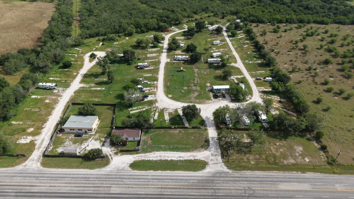 The entrance drives, park office and Highway 202 frontage at The Texas Rose RV Park in Beeville, Texas