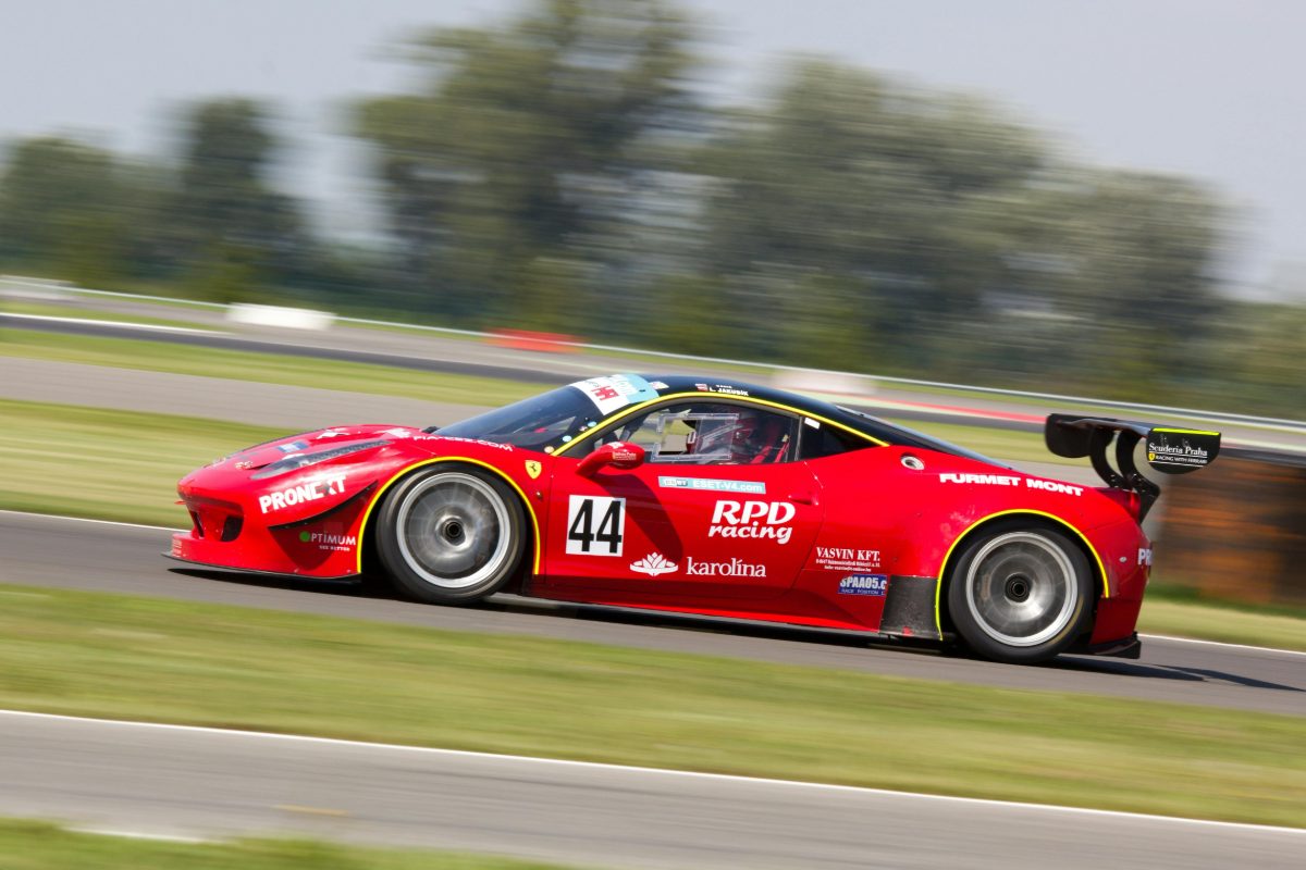 A race car at speed on a circuit